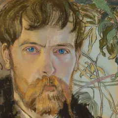 Portret mężczyzny z rudą brodą i niebieskimi oczami, w tle roślinność. Czy to przykład, jak wygląda modernizm?