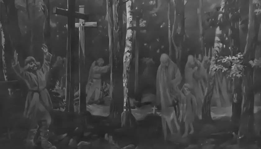 Mroczny las, krzyże, postacie w długich szatach i dziecko. Scena przypomina "mała improwizacja dziady 3".